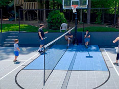 A family playing tennis in their backyard multi-court