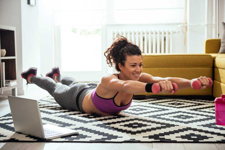 Woman working out with the help of online training