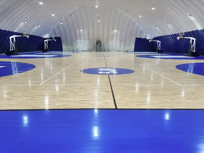 FIBA-certified Junckers hardwood court at St. Jude’s Academy in Mississauga with custom blue paint.