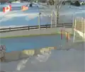 Backyard rink with Canadian and American flags