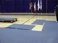 Workers installing Carpetdeck on gym flooring for an event