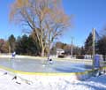 Kids practicing on a large backyard ice rink