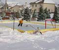 Kid practicing hockey in his backyard