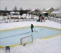 Man smoothing a a 20x40 backyard ice rink surface with a 52 NiceIce™ Resurfacer