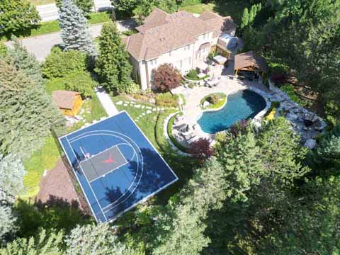 >Half Size, Blue and Grey, Outdoor Basketball Court in Aurora, ON.  Raptors Ball Logo