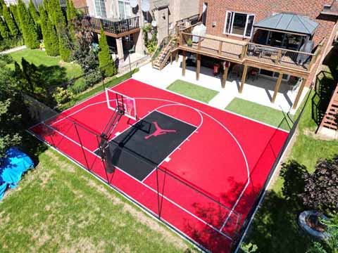 >Half Size, Red and Black Outdoor Basketball Court in Whitby, ON. Jumping man logo