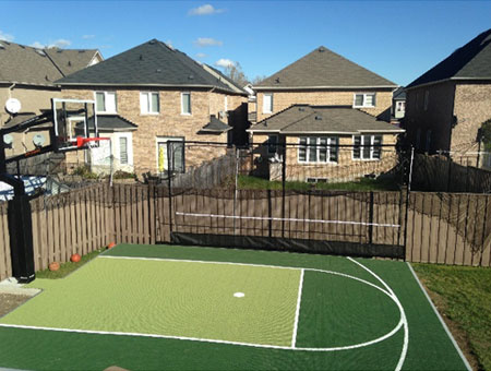 Basketball court in the backyard. Green flooring.