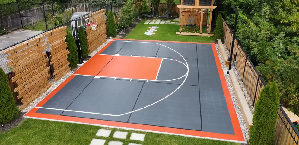 Custom 30x40 multi-game backyard court in the GTA featuring basketball lines, durable surfacing, and premium accessoriess