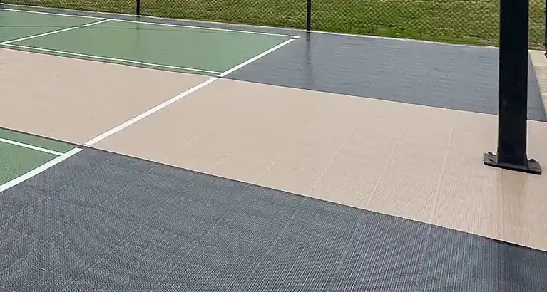 Close-up of SnapSports modular surface showing professional basketball hoop and multi-sport game lines on colorful court during fall season