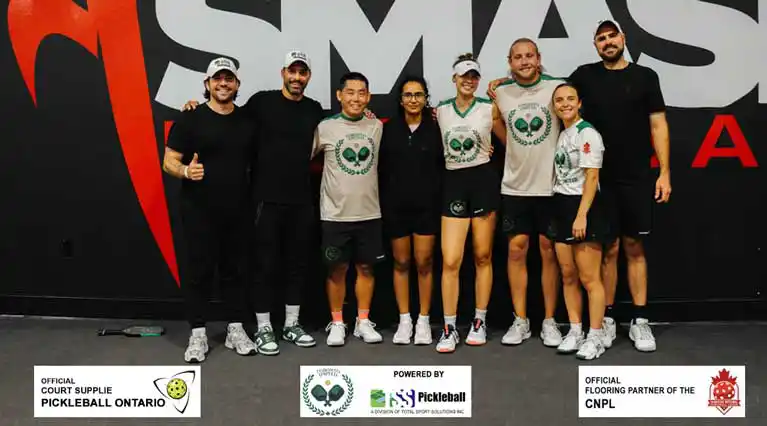 Toronto United Pickleball Club players huddle at a Canadian National Pickleball League event, with TUPC and Total Sport Solutions partner branding visible