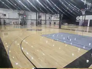 A wide view of the finished Shoot 360 basketball court highlighting the overlapping high school, FIBA, and NBA three-point lines.