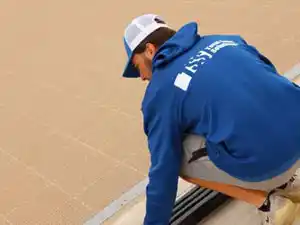 Total Sport Solutions crew installing SnapSports outdoor athletic flooring at Breslau school