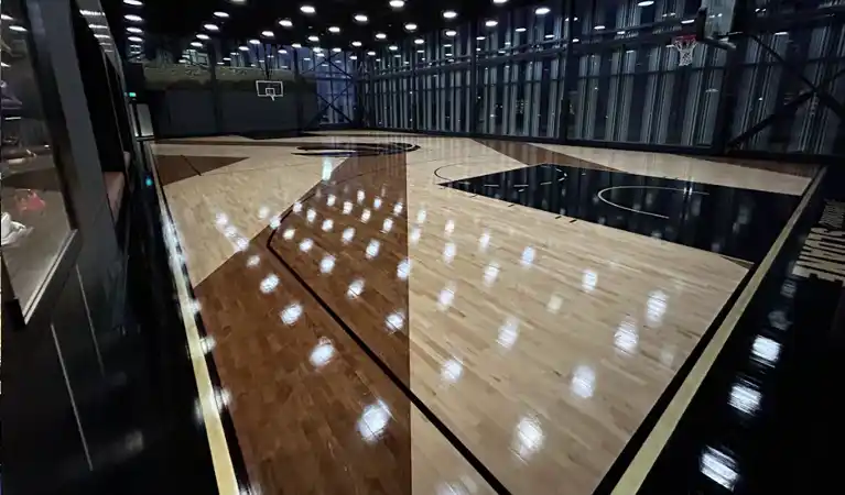 Close-up of 288 linear feet of precision brass inlay set flush into a professional Junckers hardwood basketball floor.