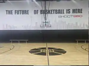 The center court area at Shoot 360 Oakville featuring 'The Future of Basketball is Here' wall graphic and pristine hardwood floors.