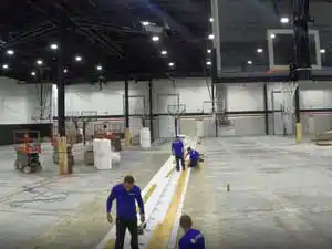 Total Sport Solutions team beginning the installation of Junckers hardwood sports flooring at the Shoot 360 facility in Oakville, Ontario.