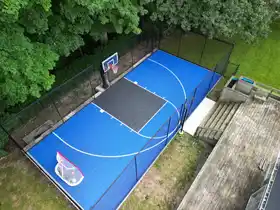 Expert installation of a medium-sized court in North York. The all-weather sport tile surface and durable safety fencing create the ultimate backyard play zone.