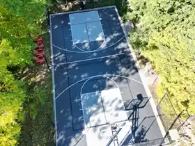 Built for the whole family, this 29' by 59' court offers basketball, pickleball, and volleyball, secured by full containment and court lighting.