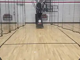 High-tech automated basketball shooting cage at Shoot 360 Oakville. Total Sport Solutions installed premium Junckers hardwood flooring is engineered to withstand intense, high-repetition robotic training.