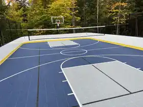 A premium 2,160 sq ft custom backyard court in Parry, featuring unique blue and gray zones for basketball, hockey, pickleball and volleyball. Perimeter dasher boards and high containment netting.<br />
 