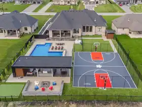 This large 48' by 60' multi-game court in Brantford features dual hoops and full containment netting, supporting basketball, pickleball, and volleyball for the family.