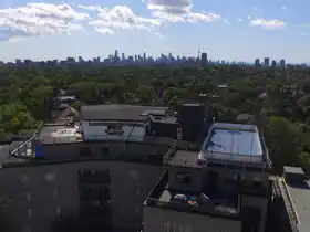 Custom rooftop multi-sport court installation overlooking the Toronto skyline. Features a specialized surface, dasher boards for hockey, and a dedicated half-basketball court