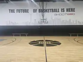 Pristine center court area at Shoot 360 in Oakville, ON. Total Sport Solutions delivered high-gloss Junckers hardwood court installation featuring flawless custom facility branding and precise line painting, matching the elite aesthetic of Ontario's most advanced training facility.