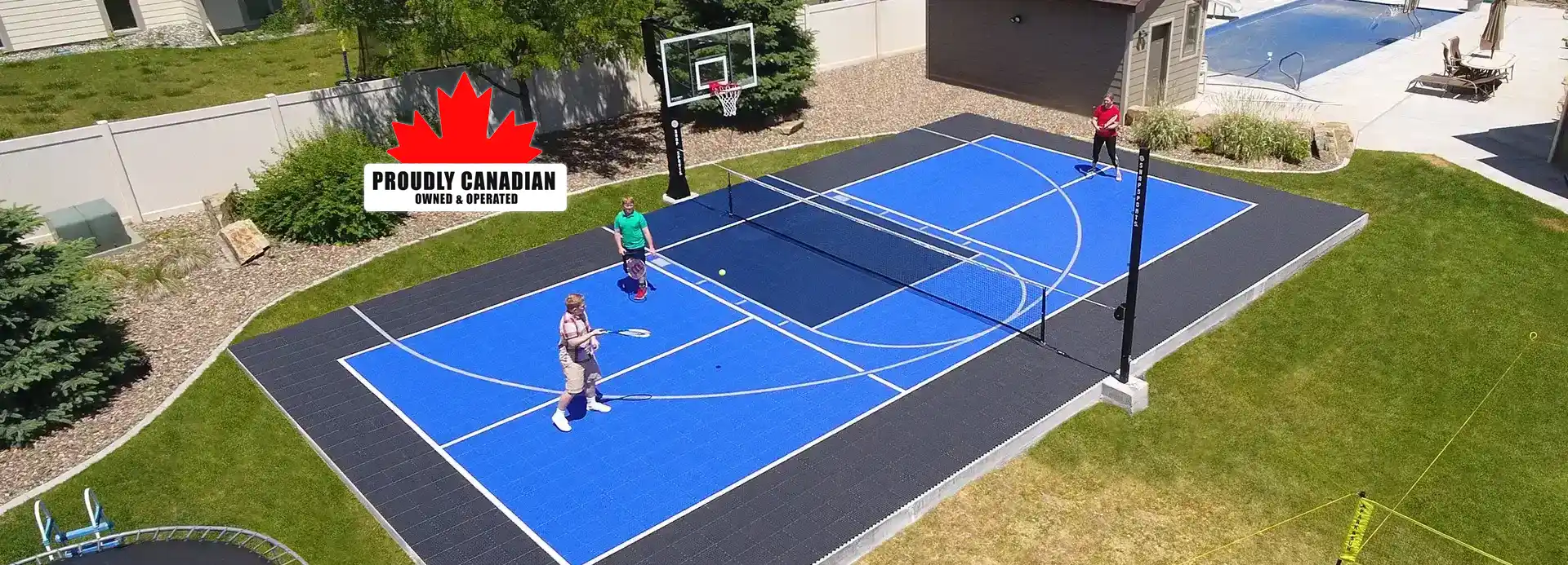 Father and kids having a good time while playing basketball on their backyard court