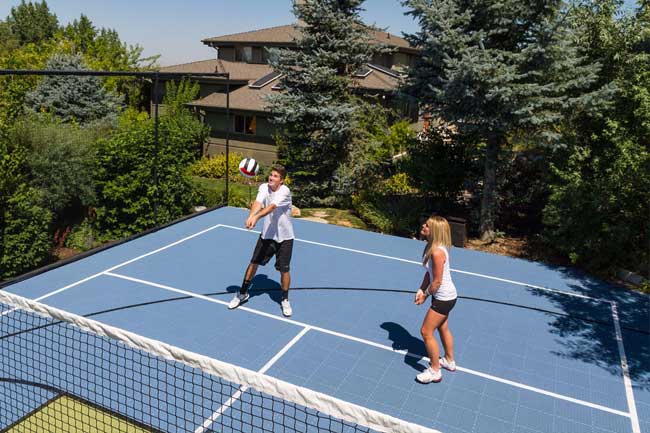 Famlity playing Volleyball in their backyard court