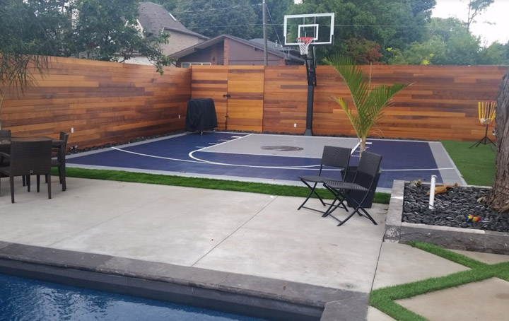 Basketball Back yard court in Etobicoke with raptors Logo.